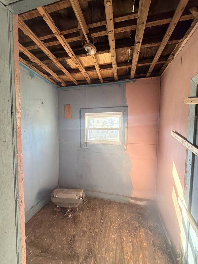 Room with ceiling opened up to the joists