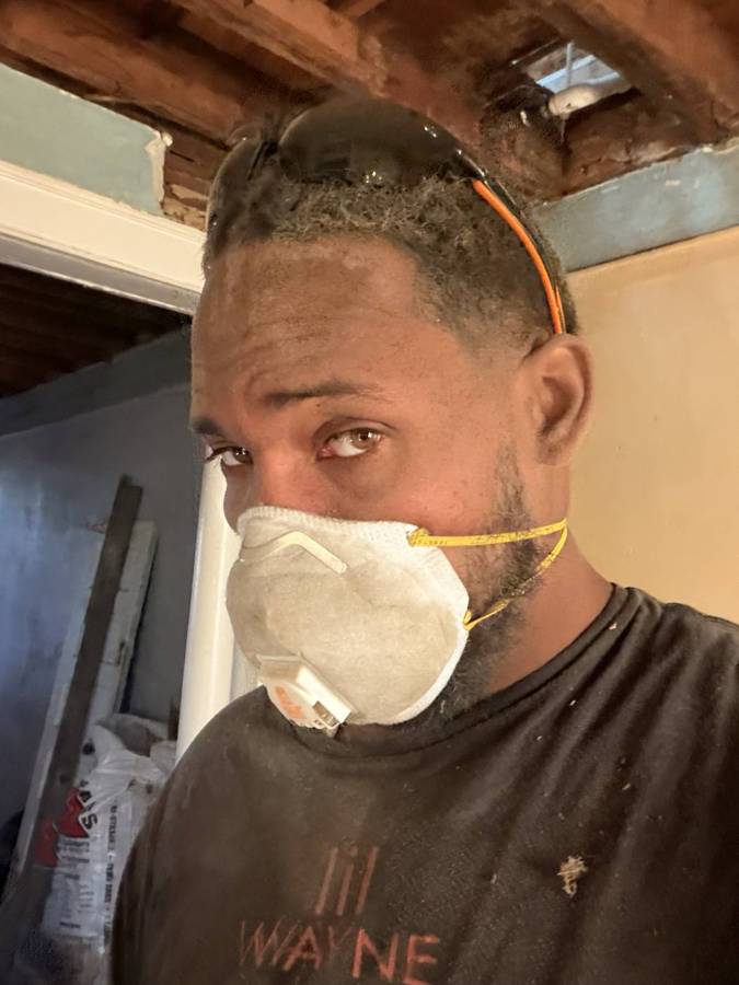 Damage Dude crew member on site in a dust mask